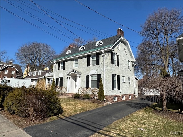 view of front of house featuring a chimney