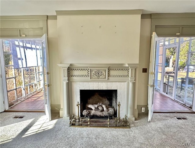 details featuring a brick fireplace, carpet, and visible vents