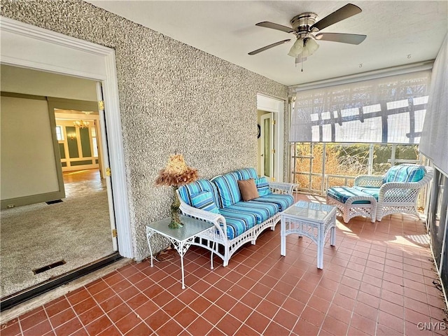 sunroom featuring visible vents and ceiling fan with notable chandelier