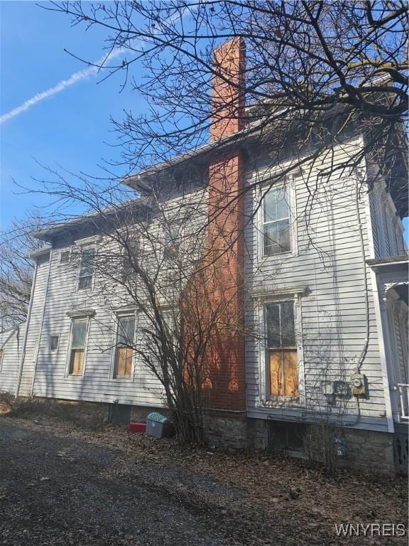 view of side of home featuring a chimney