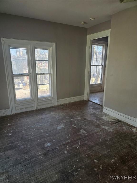 empty room with wood finished floors and baseboards