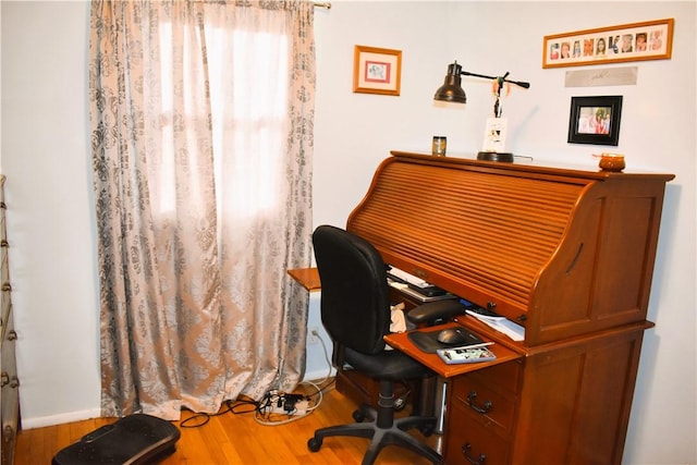 office space featuring a dry bar and wood finished floors