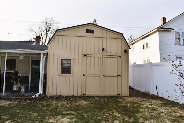 view of shed featuring fence