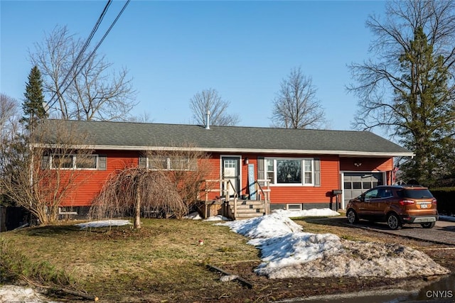 single story home featuring a garage and a front lawn