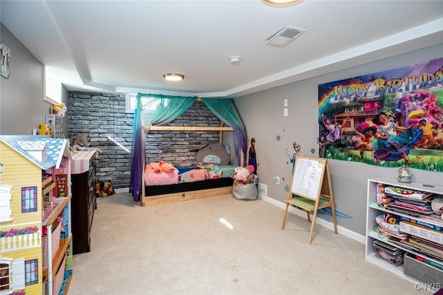 carpeted bedroom featuring baseboards, visible vents, and brick wall