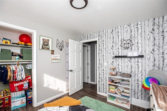 game room with baseboards and wood finished floors