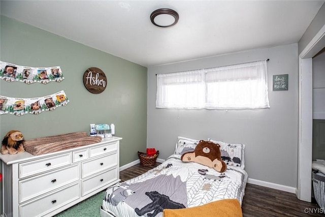 bedroom featuring baseboards and dark wood finished floors