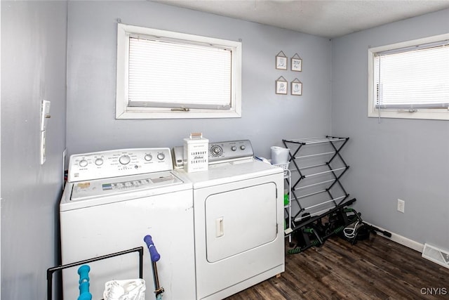 laundry room with visible vents, dark wood finished floors, separate washer and dryer, baseboards, and laundry area