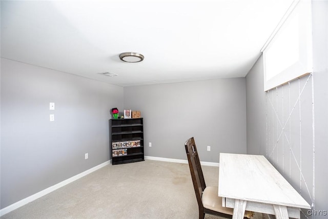 home office featuring baseboards and light colored carpet