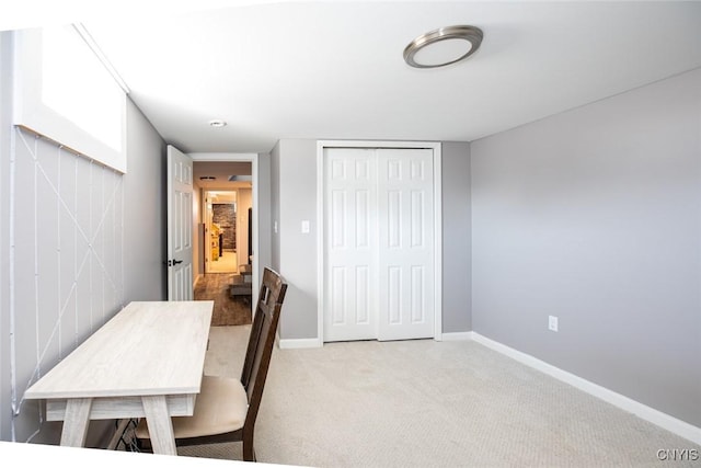 carpeted office featuring baseboards