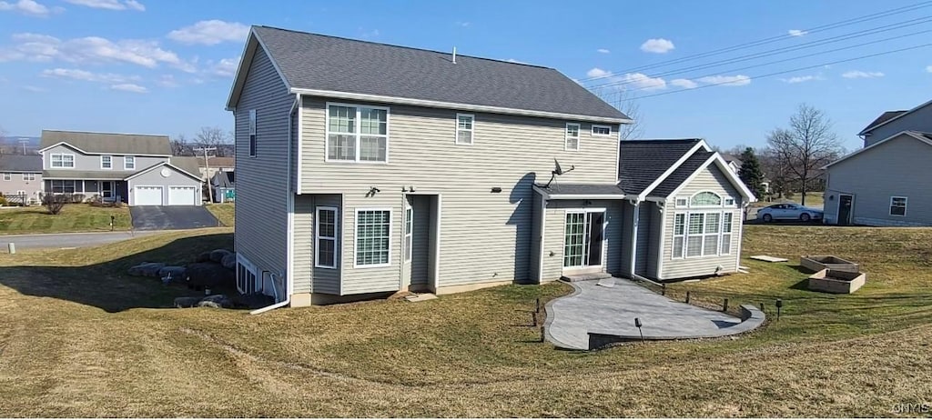 rear view of house with a yard and an outdoor structure