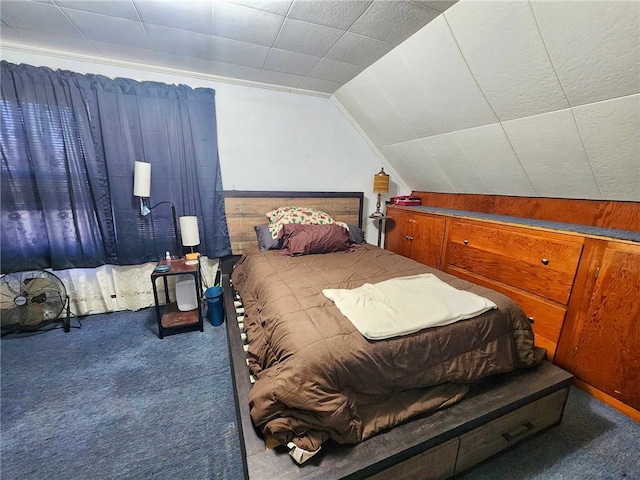 bedroom with carpet flooring and lofted ceiling