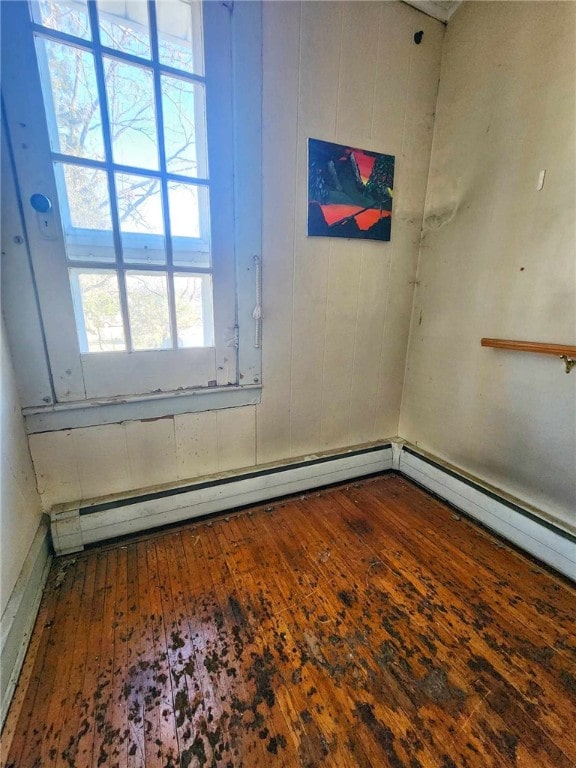 empty room featuring hardwood / wood-style floors and wood walls