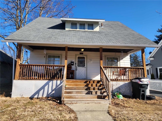 bungalow-style house with covered porch and a shingled roof