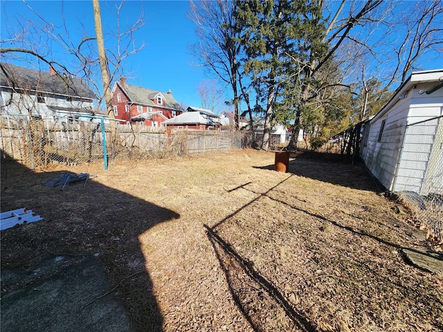 view of yard featuring a residential view and a fenced backyard