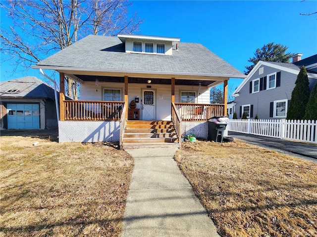 bungalow featuring fence and covered porch