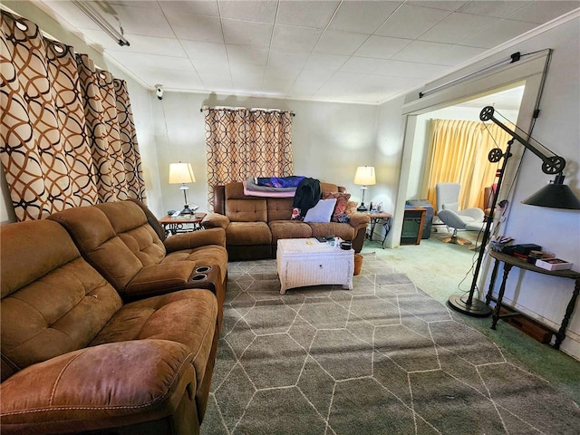 living room featuring crown molding and dark colored carpet