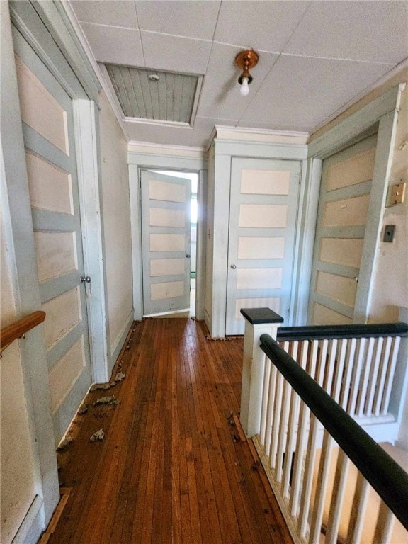 hall with an upstairs landing and dark wood-style floors