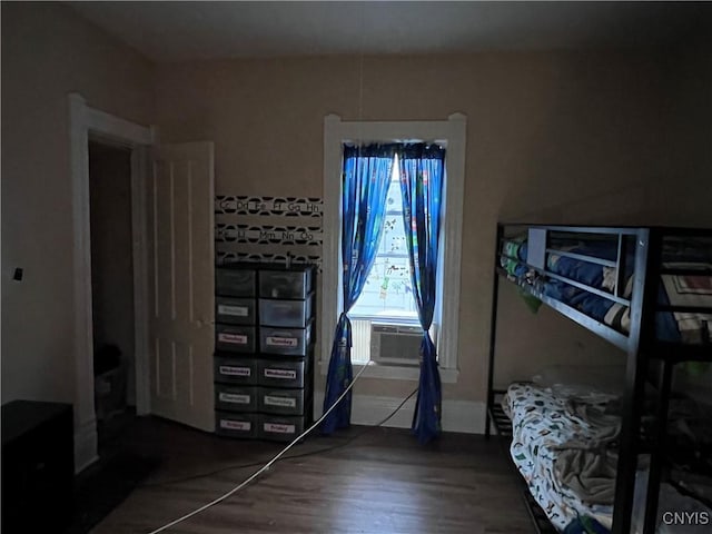 bedroom with dark wood-type flooring