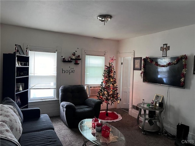 carpeted living room with cooling unit and baseboards