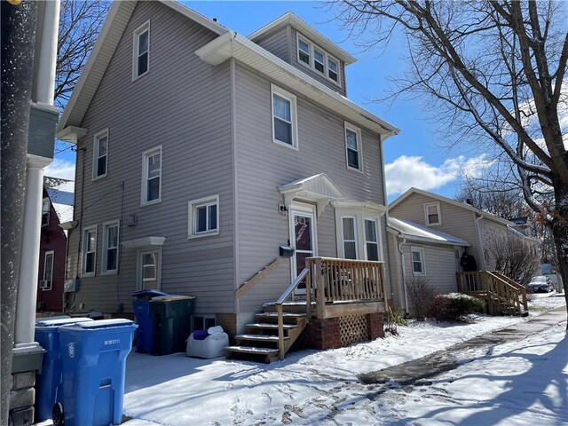 view of snow covered rear of property