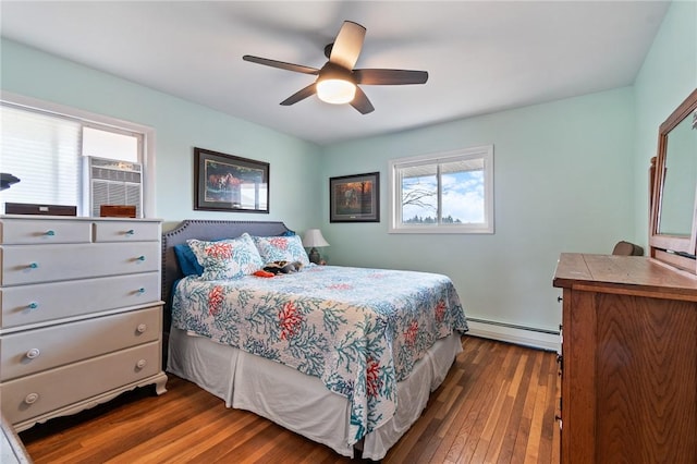 bedroom featuring ceiling fan, dark wood-type flooring, and a baseboard radiator