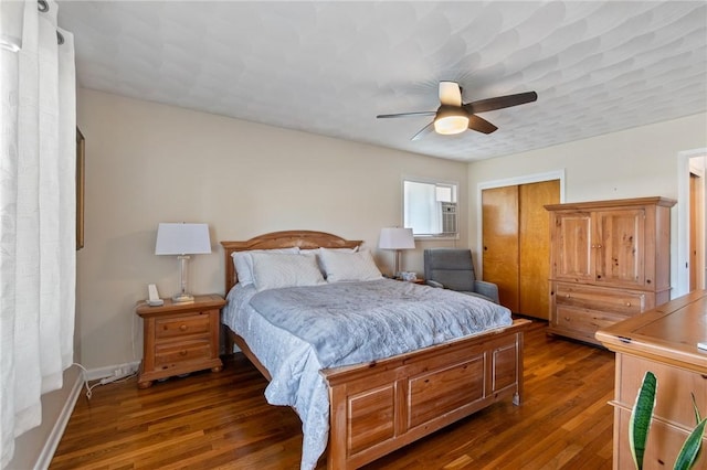 bedroom featuring a ceiling fan, wood finished floors, a closet, and baseboards