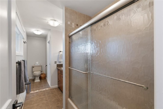 full bathroom with baseboards, toilet, a stall shower, tile patterned floors, and vanity