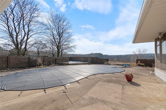 view of swimming pool featuring a patio area, a fenced in pool, and a fenced backyard