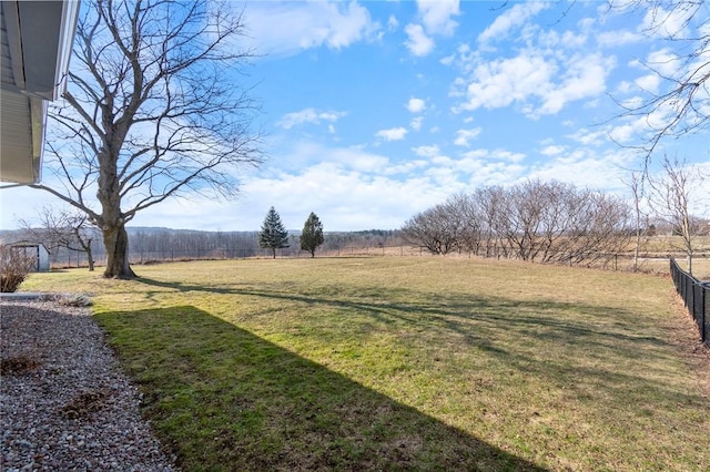 view of yard with a rural view and fence