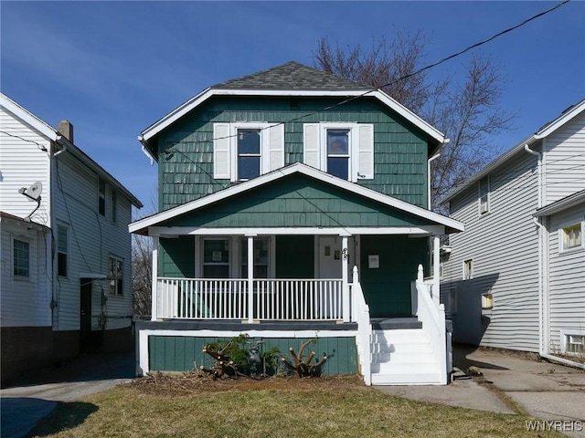 american foursquare style home featuring covered porch