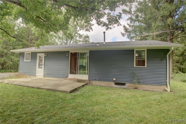 rear view of property featuring a patio and a lawn