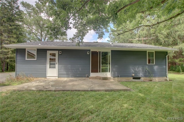 back of property with a patio and a lawn