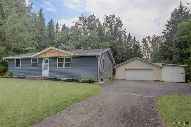 ranch-style home with a front yard, an outbuilding, and a detached garage