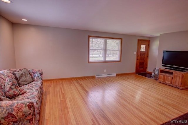 living room featuring light wood-style floors, baseboards, and a baseboard radiator