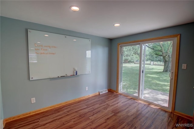 empty room with visible vents, recessed lighting, baseboards, and wood finished floors