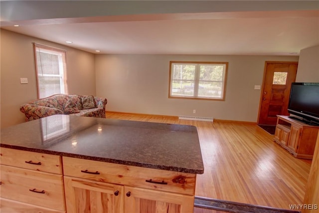 kitchen with light brown cabinetry, plenty of natural light, and light wood-type flooring