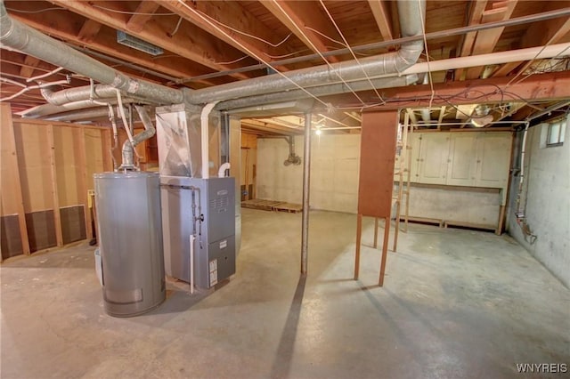 unfinished basement featuring heating unit and water heater