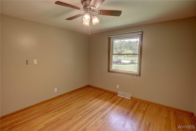 unfurnished room featuring visible vents, baseboards, light wood-style floors, and a ceiling fan