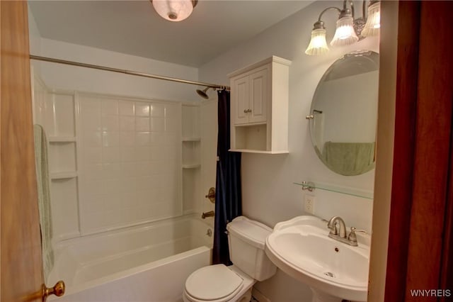 bathroom featuring toilet, shower / bathtub combination with curtain, and a sink