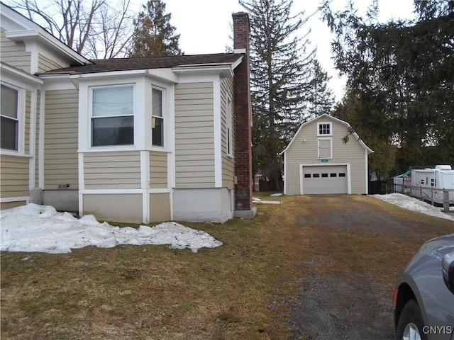 32 Fenner St, Cazenovia, NY 13035 - view of side of home featuring a detached garage, an outbuilding, and a chimney