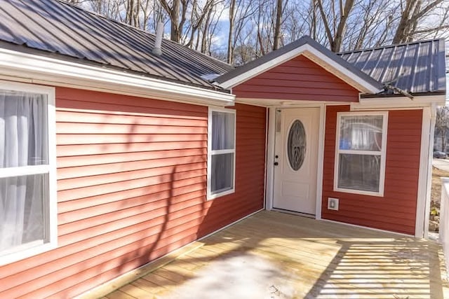 property entrance with metal roof and a standing seam roof