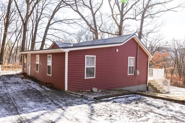 snow covered property with metal roof