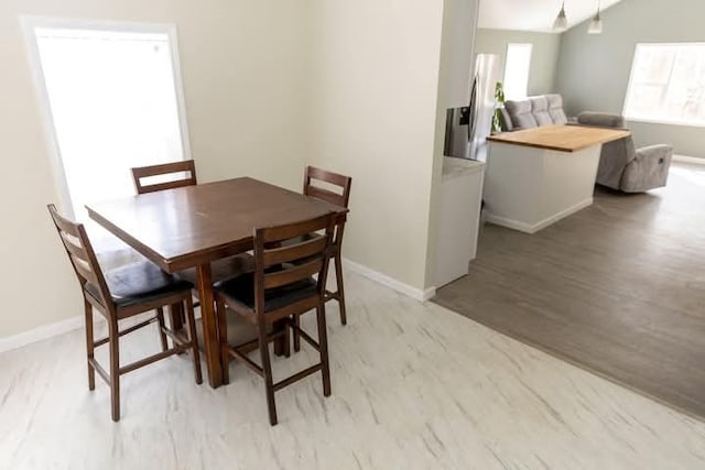 dining area with wood finished floors and baseboards