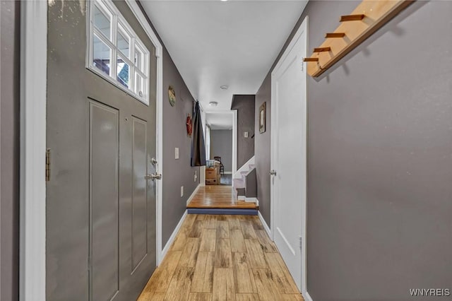 interior space featuring light wood-style flooring and baseboards