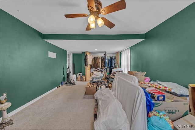 carpeted bedroom featuring baseboards and ceiling fan