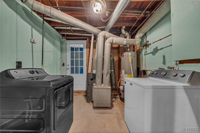 clothes washing area with washing machine and clothes dryer, laundry area, and water heater