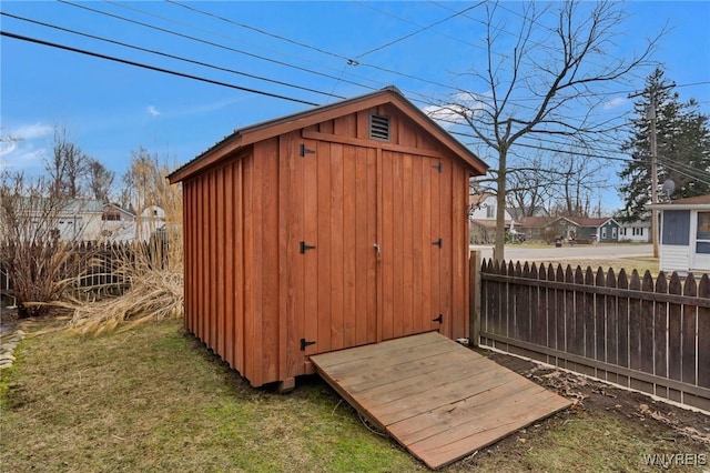 view of shed with fence and a residential view