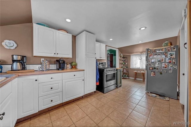 kitchen featuring light countertops, recessed lighting, light tile patterned flooring, white cabinets, and stainless steel appliances