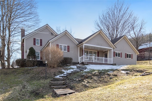 traditional-style home featuring covered porch and a chimney